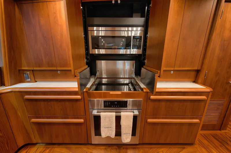 Slide: The Image of Luxurious kitchen in 2016 Merritt 86' Enclosed Flybridge yacht with modern appliances. - 46