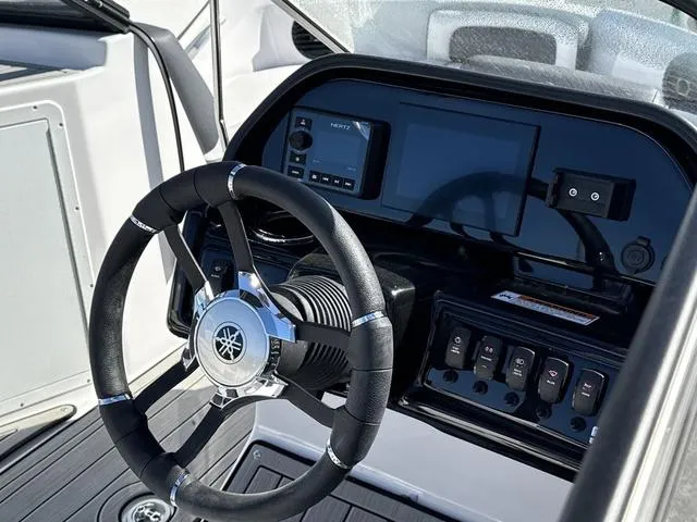 Slide: The Image of 2025 Yamaha Boats 195S dashboard with steering wheel and control panel. - 16