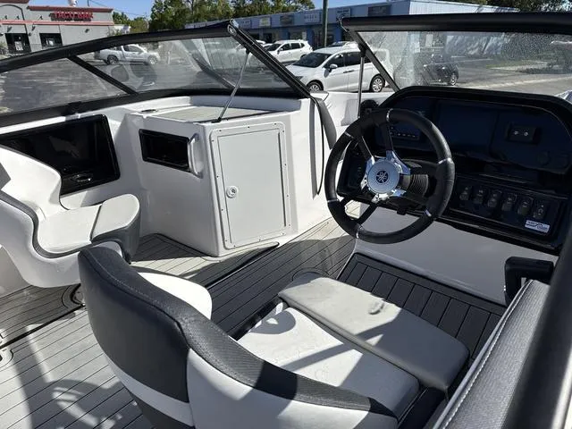 Slide: The Image of 2025 Yamaha Boats 195S interior, mist gray and black seating, modern design. - 9