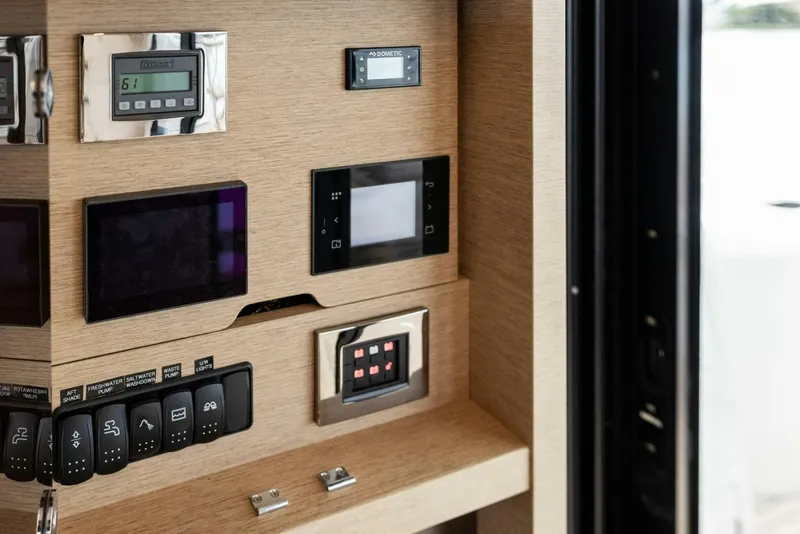 Slide: The Image of Control panel of 2022 Prestige 520 yacht with various electronic displays and switches. - 13