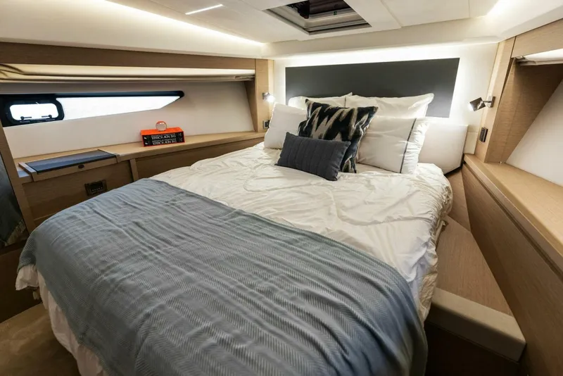 Slide: The Image of Luxurious bedroom interior of 2022 Prestige 520 yacht with modern design and cozy bedding. - 19