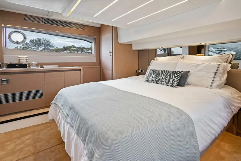 Slide: The Image of Luxurious bedroom interior of 2022 Prestige 520 yacht with modern design and scenic window view. - 2