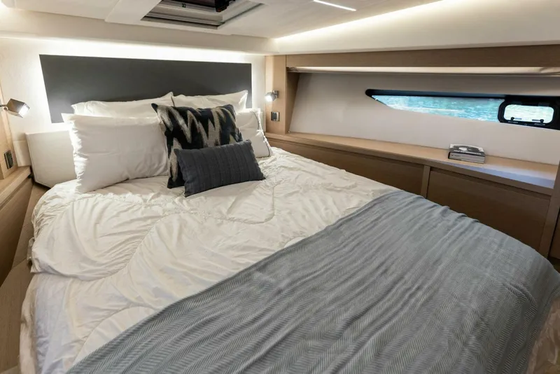Slide: The Image of Luxurious 2022 Prestige 520 yacht bedroom with modern design and cozy bedding. - 20