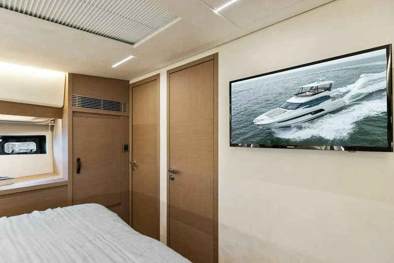 Slide: The Image of Luxurious interior of 2022 Prestige 520 yacht with modern decor and wall-mounted TV. - 21