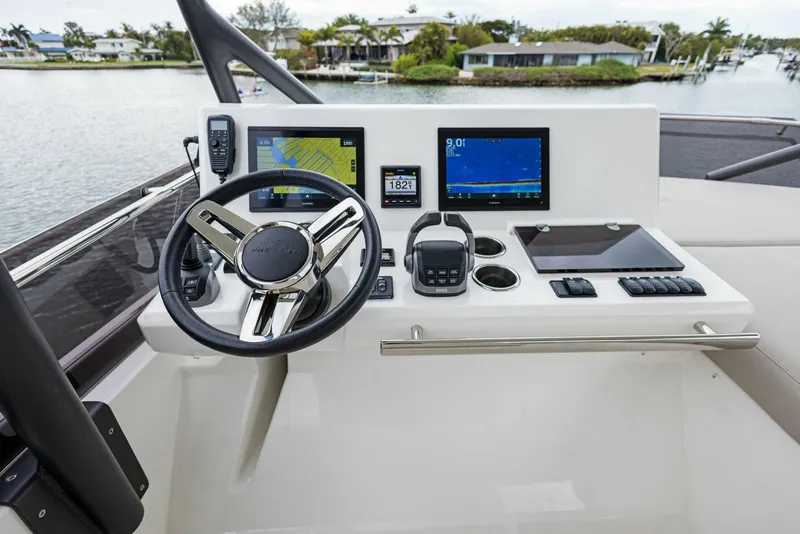 Slide: The Image of Prestige 520 yacht helm with modern navigation displays, 2022 model. - 27