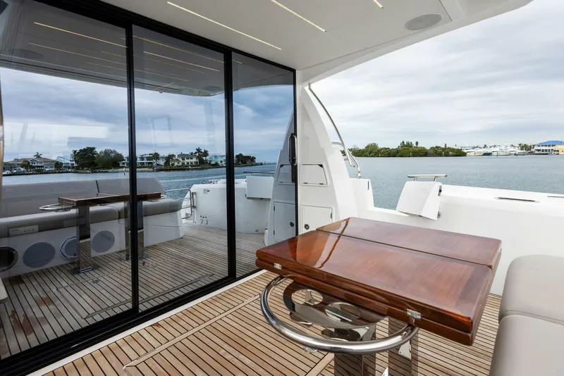 Slide: The Image of Luxurious 2022 Prestige 520 yacht interior with sleek wooden table and scenic water view. - 28