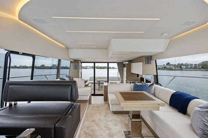 Slide: The Image of Luxurious interior of 2022 Prestige 520 yacht with modern seating and panoramic windows. - 3