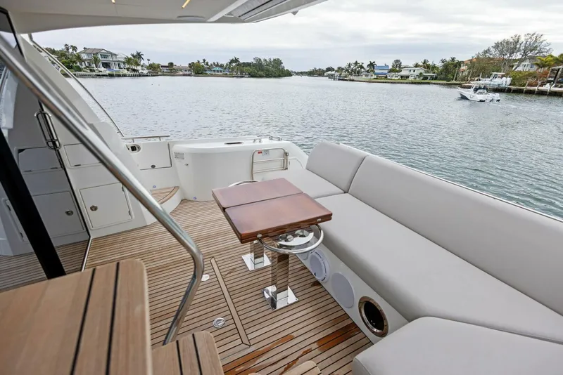 Slide: The Image of Luxurious 2022 Prestige 520 yacht deck with seating and scenic waterfront view. - 30