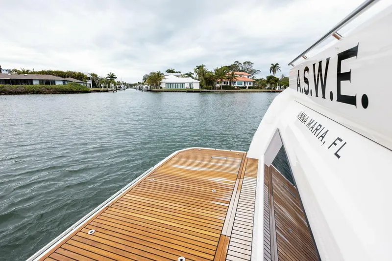 Slide: The Image of Prestige 520 yacht, 2022 model, docked in Anna Maria, FL, with scenic waterfront view. - 32