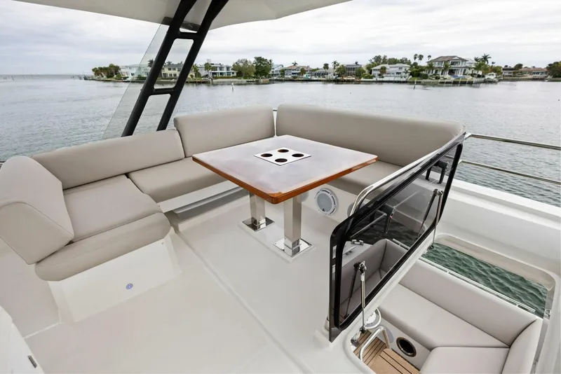 Slide: The Image of Luxurious seating area on 2022 Prestige 520 yacht with scenic waterfront view. - 34
