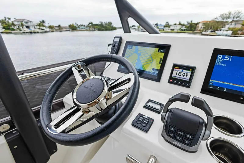 Slide: The Image of Prestige 520 yacht helm with navigation screens and controls, 2022 model. - 37