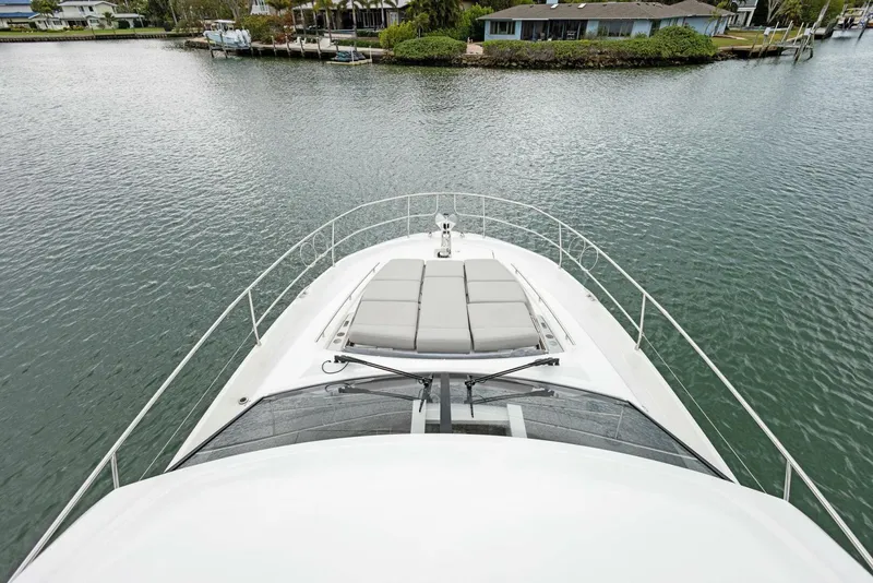 Slide: The Image of Prestige 520 yacht bow view, 2022 model, on calm water near shoreline. - 39