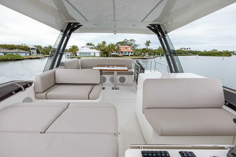 Slide: The Image of Luxurious 2022 Prestige 520 yacht interior with elegant seating and scenic waterfront view. - 4