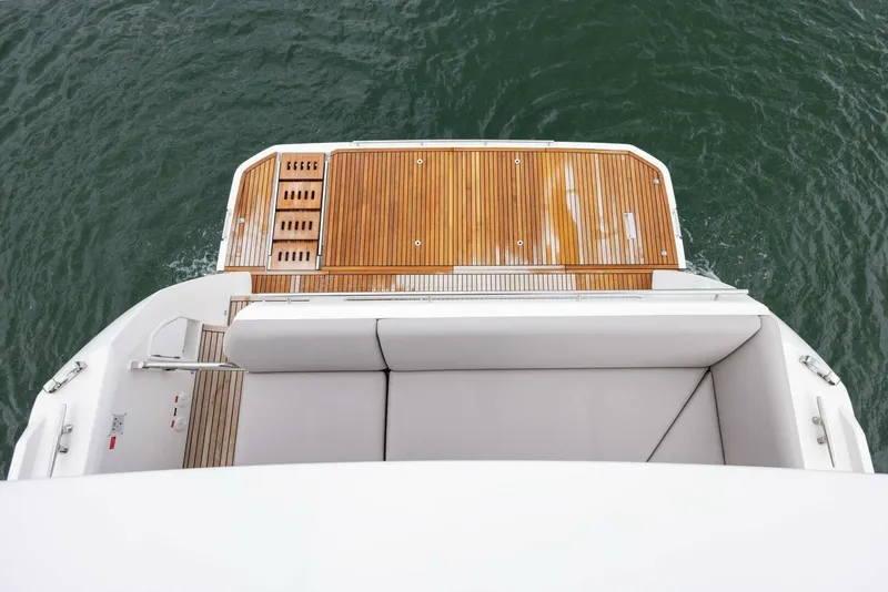 Slide: The Image of Prestige 520 yacht, 2022 model, featuring a sleek wooden deck and comfortable seating. - 40