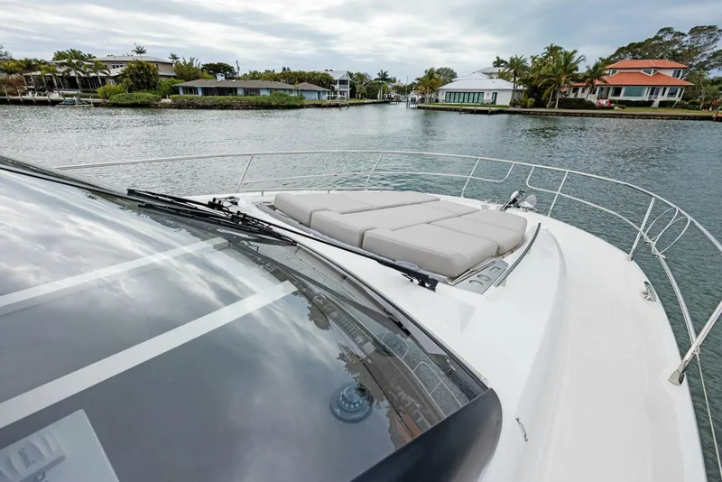 Slide: The Image of 2022 Prestige 520 yacht on calm water with luxurious deck seating. - 42