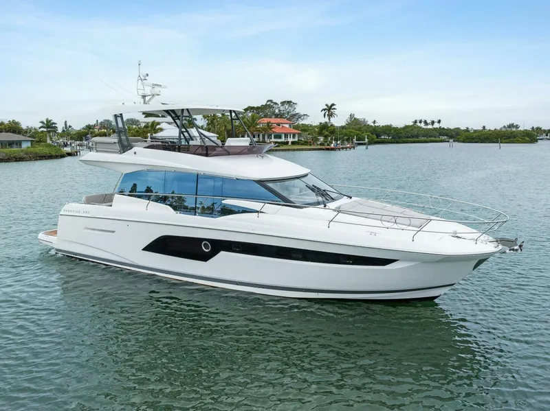 Slide: The Image of Luxury 2022 Prestige 520 yacht cruising on serene waters. - 47