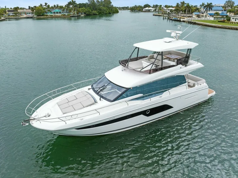 Slide: The Image of Luxury 2022 Prestige 520 yacht cruising in serene waters. - 49