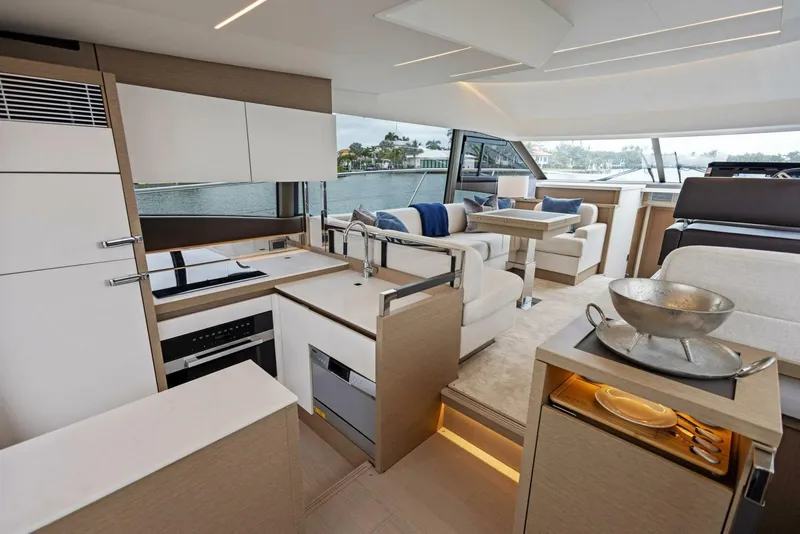Slide: The Image of Luxurious interior of 2022 Prestige 520 yacht with modern kitchen and seating area. - 5