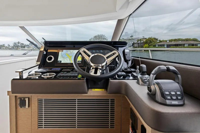 Slide: The Image of Prestige 520 yacht helm, 2022 model, featuring advanced navigation and control systems. - 9