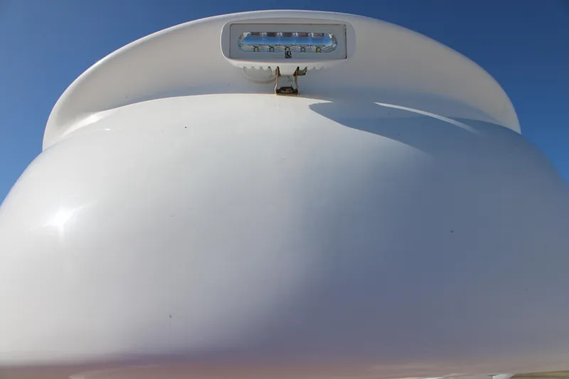 Slide: The Image of 2022 Front Runner 26 Center Console boat detail with LED light against blue sky. - 12