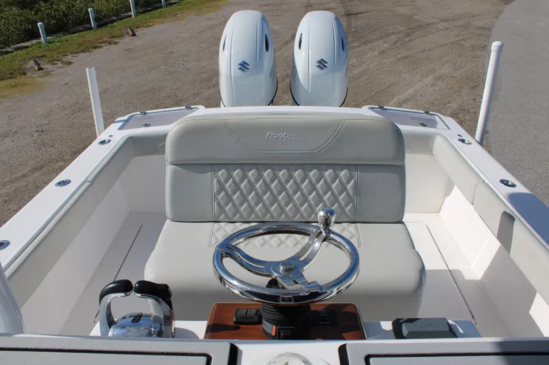 Slide: The Image of 2022 Front Runner 26 Center Console boat with dual engines and sleek steering wheel design. - 13