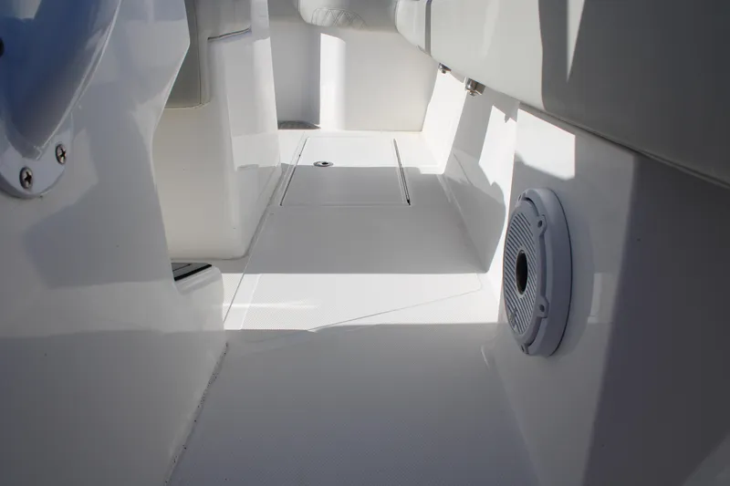 Slide: The Image of 2022 Front Runner 26 Center Console interior with sleek white design and built-in speaker. - 14