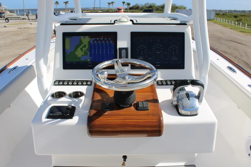 Slide: The Image of 2022 Front Runner 26 Center Console boat dashboard with dual displays and steering wheel. - 15