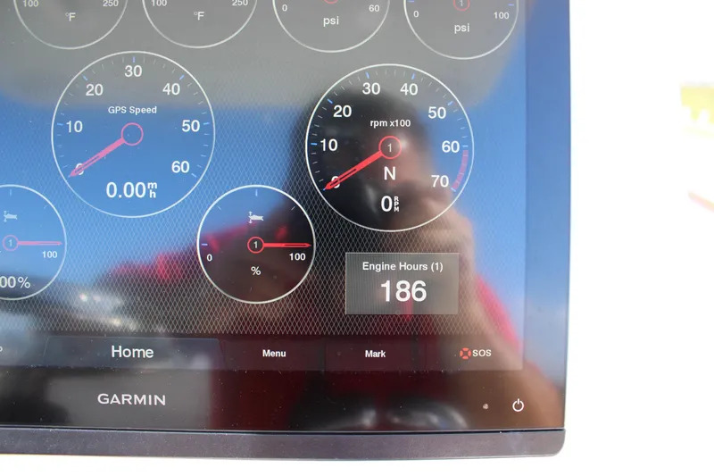 Slide: The Image of Garmin display on 2022 Front Runner 26 Center Console showing engine hours and gauges. - 19