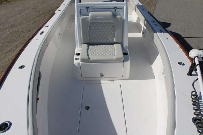 Slide: The Image of 2022 Front Runner 26 Center Console boat interior with cushioned seating. - 2