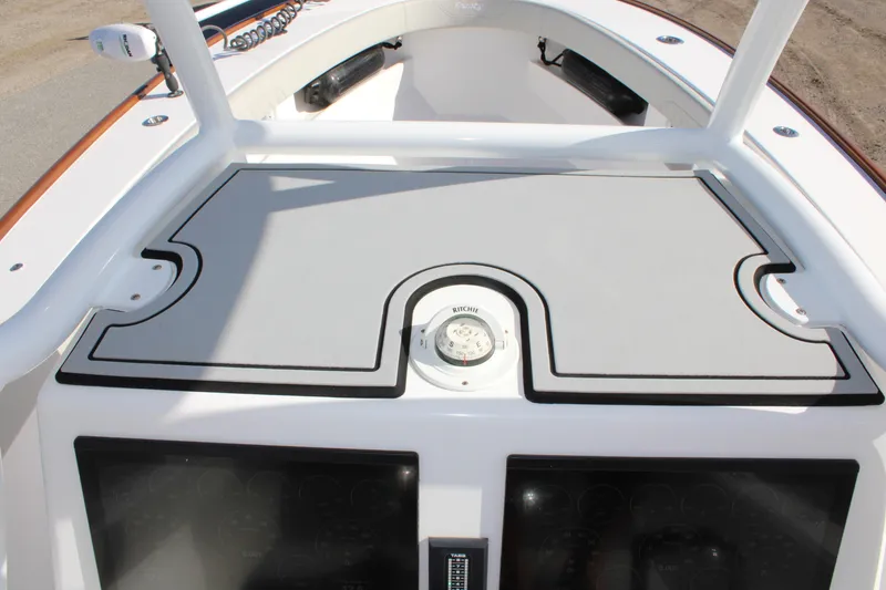 Slide: The Image of 2022 Front Runner 26 Center Console boat deck with compass and storage compartments. - 22