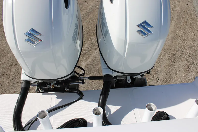 Slide: The Image of Twin Suzuki outboard engines on a 2022 Front Runner 26 Center Console boat. - 30