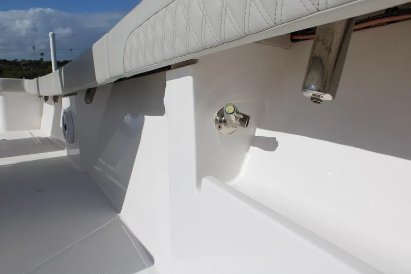 Slide: The Image of 2022 Front Runner 26 Center Console boat interior with sleek white finish and cushioned seating. - 6