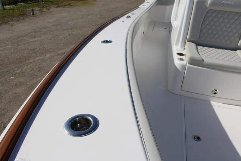 Slide: The Image of 2022 Front Runner 26 Center Console boat deck with seating and cup holders. - 8