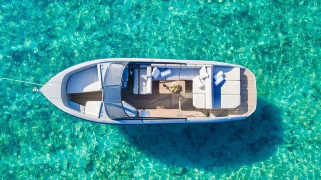 Slide: The Image of Aerial view of 2024 Rand Supreme 27 boat on clear turquoise water. - 2