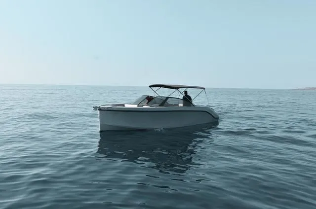 Slide: The Image of 2024 Rand Supreme 27 boat cruising on calm ocean waters. - 3