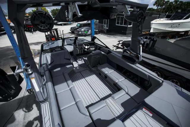 Slide: The Image of 2024 Nautique S23 boat interior with sleek gray seating and advanced audio system. - 11