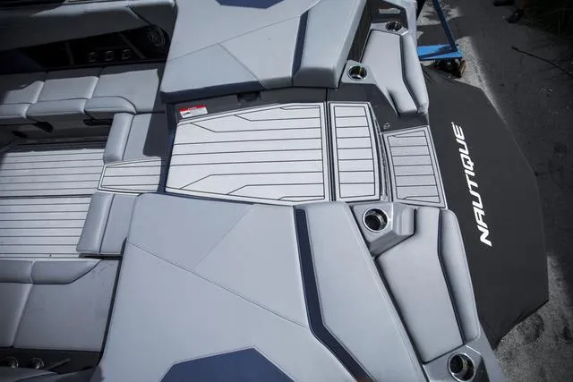 Slide: The Image of 2024 Nautique S23 boat interior with sleek gray seating and modern design. - 12