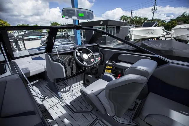 Slide: The Image of 2024 Nautique S23 boat interior with modern dashboard and seating. - 13