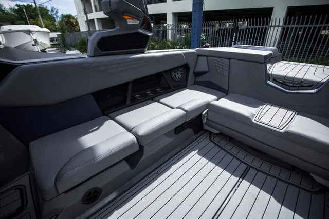 Slide: The Image of 2024 Nautique S23 boat interior with sleek gray seating and modern design. - 14