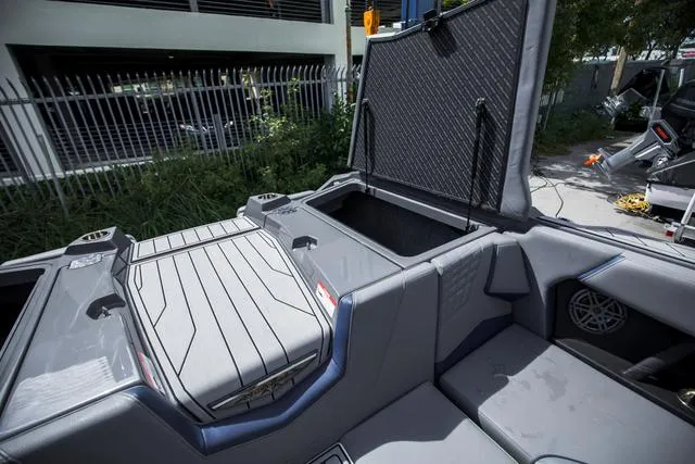 Slide: The Image of 2024 Nautique S23 boat interior with open storage compartments. - 16