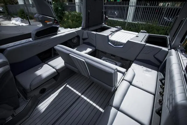 Slide: The Image of 2024 Nautique S23 boat interior with sleek gray seating and modern design. - 17