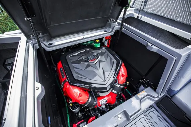 Slide: The Image of 2024 Nautique S23 boat engine compartment with PCM engine, open hatch view. - 19