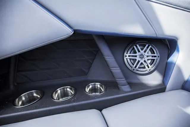 Slide: The Image of 2024 Nautique S23 interior with speaker and cup holders. - 21