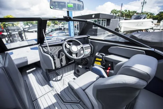 Slide: The Image of 2024 Nautique S23 boat interior with modern steering and seating design. - 24