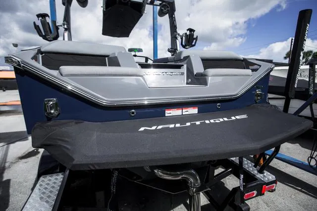 Slide: The Image of 2024 Nautique S23 boat rear view with sleek design and branding. - 9