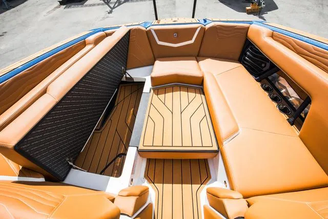 Slide: The Image of Luxurious 2025 Nautique G25 boat interior with tan leather seating and sleek design. - 12