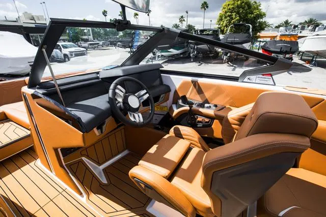 Slide: The Image of 2025 Nautique G25 boat interior with luxurious seating and modern dashboard design. - 14