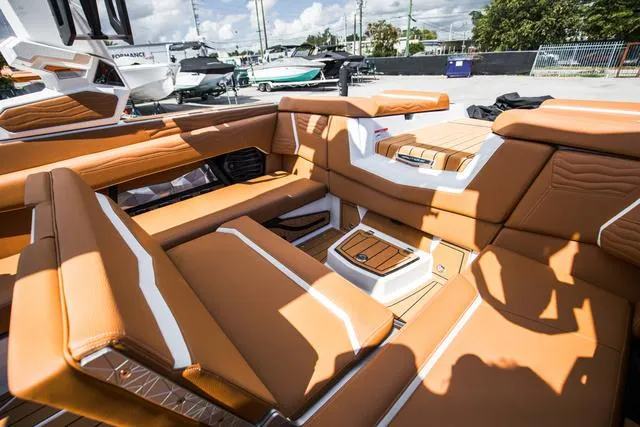 Slide: The Image of 2025 Nautique G25 boat interior with luxurious tan seating and modern design. - 21