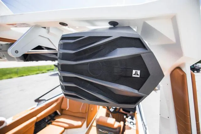 Slide: The Image of 2025 Nautique G25 boat with JL Audio speaker, brown interior, and sleek design. - 22