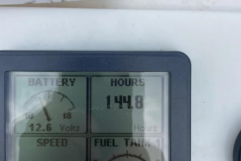 Slide: The Image of Digital display showing 1448 hours and 12.6 volts on Tripp Angler 22, 1993 model. - 10